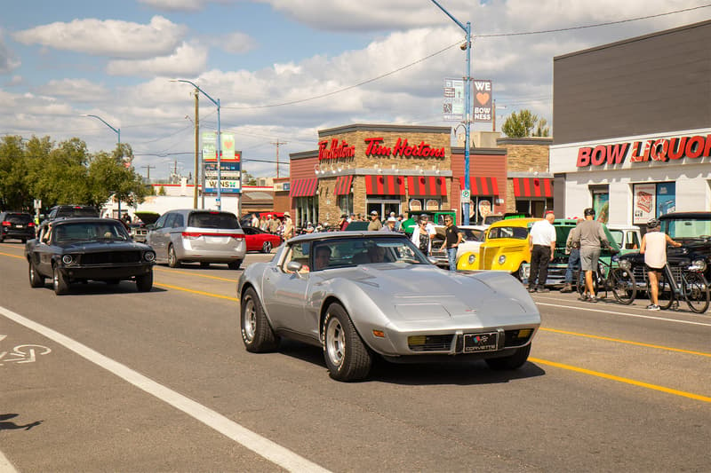 A Corvette and Mustang cruising down Bowness Road