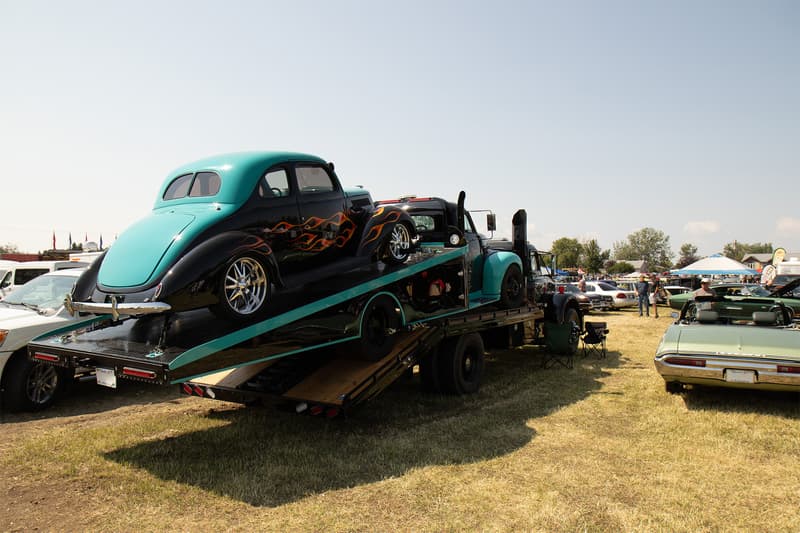 Trifecta of cool as a late thirties Ford Coupe sits atop of a Studebaker ramp truck that sits atop a Diamond T ramp truck