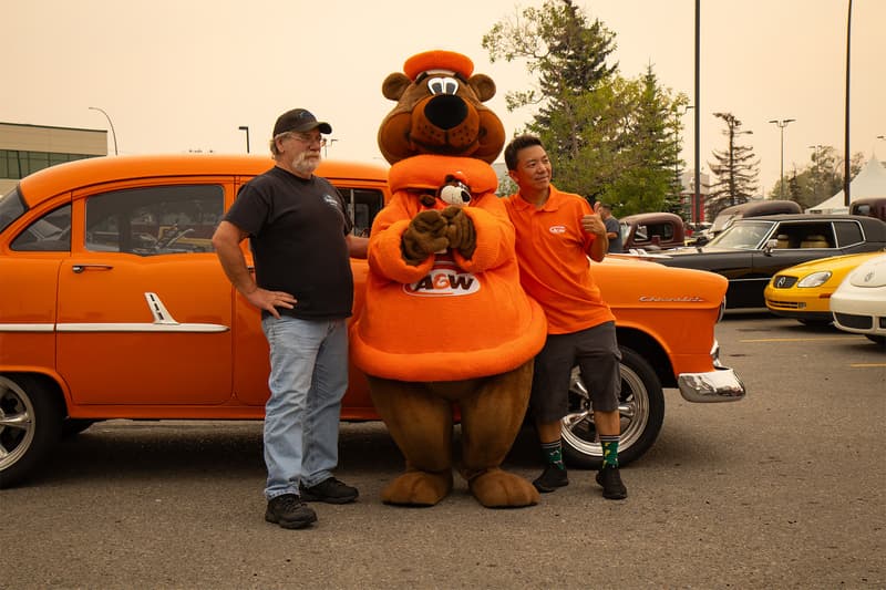 Rooty The Root Bear, Donny and the owner of the 1955 Chevrolet all pose together adorning the familiar orange of A&W's famous iconic colour