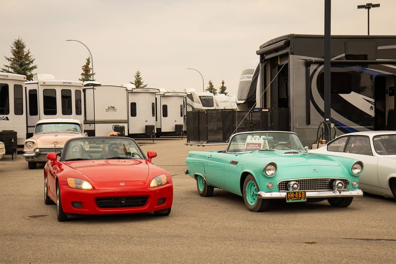 A pair of roadster sports car from nearly 50 years apart perched together in harmony.