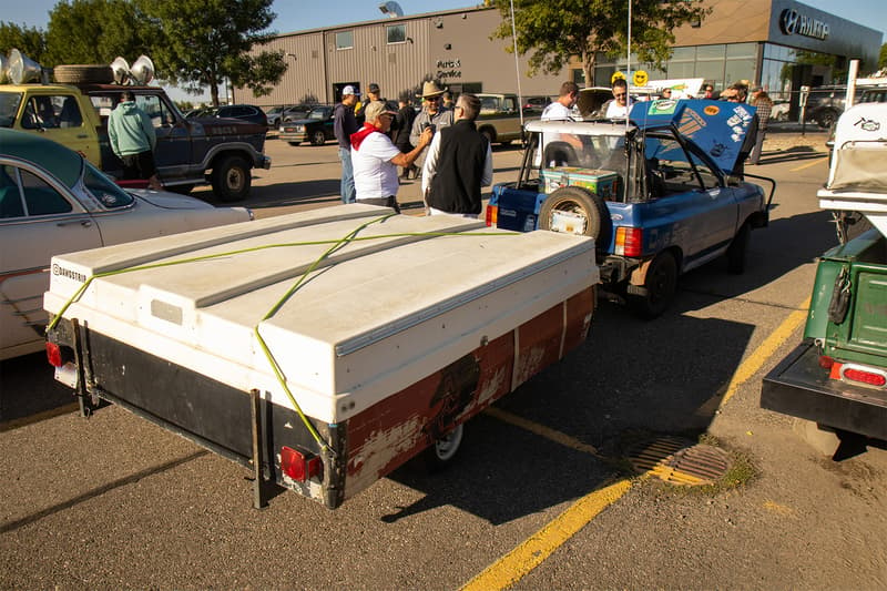 A shortened Ford Festiva with a camper trailer in tow